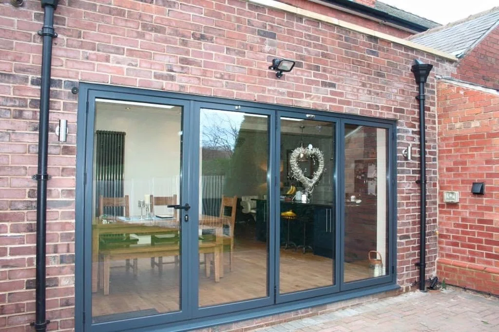 Brick extension with glazed doors opening to the garden